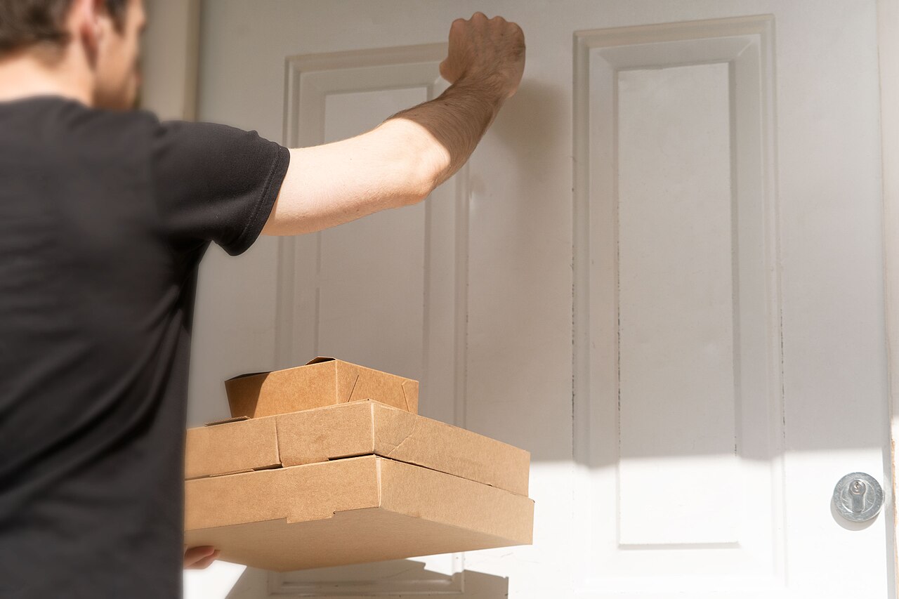 Courier arriving at a door with packaged items