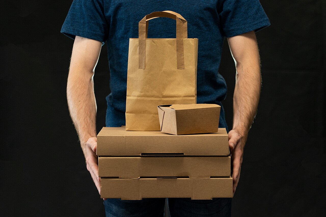Courier holding several packaged items ready for delivery
